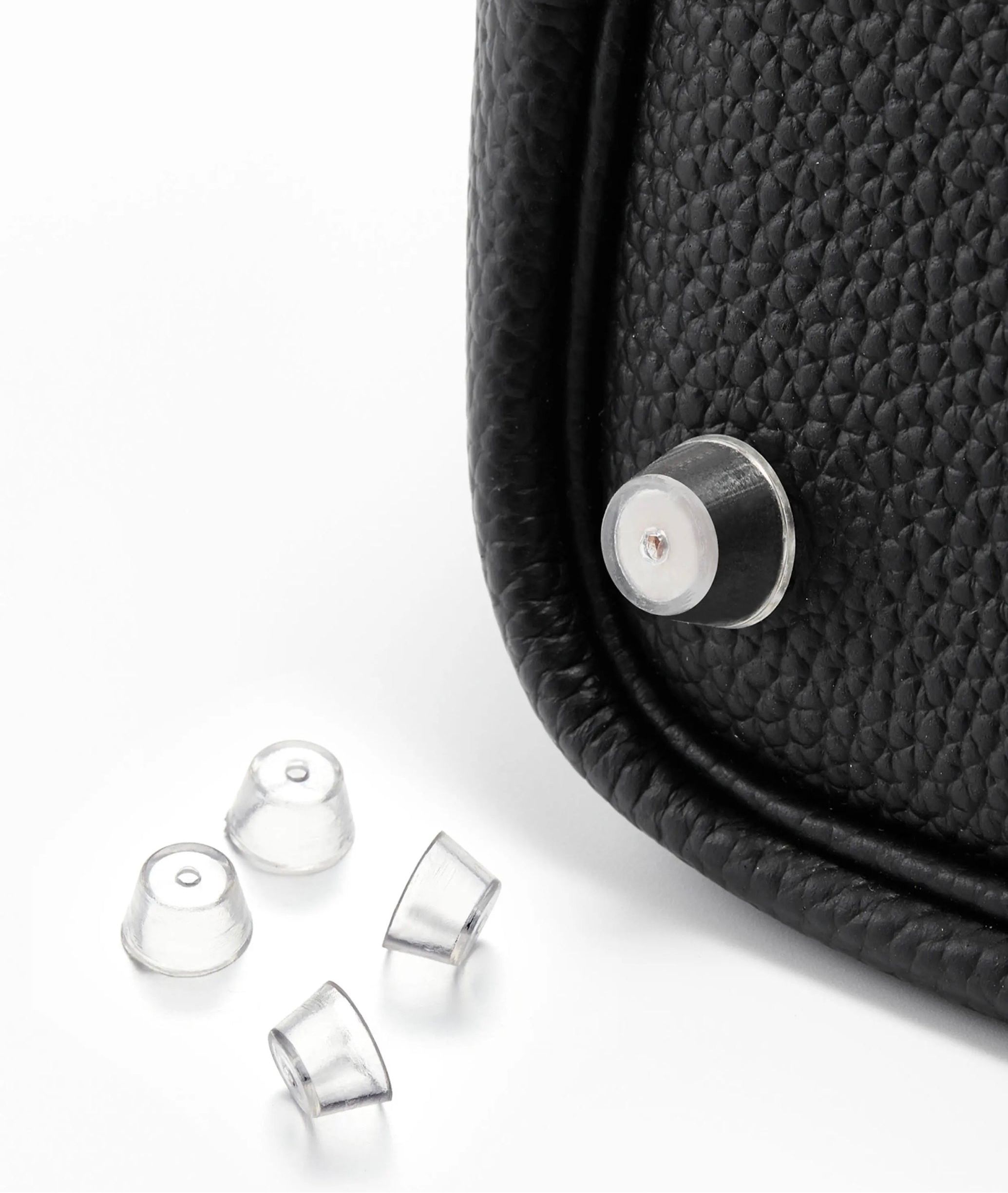 Orliná transparent feet stud protector installed on Hermès bag to prevent scratches