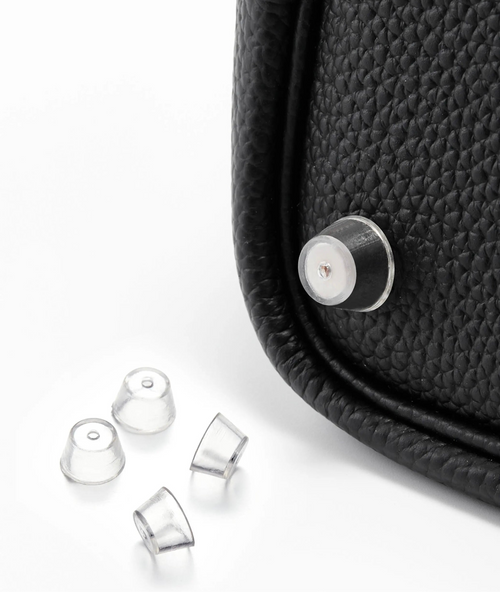 Orliná transparent feet stud protector installed on Hermès bag to prevent scratches