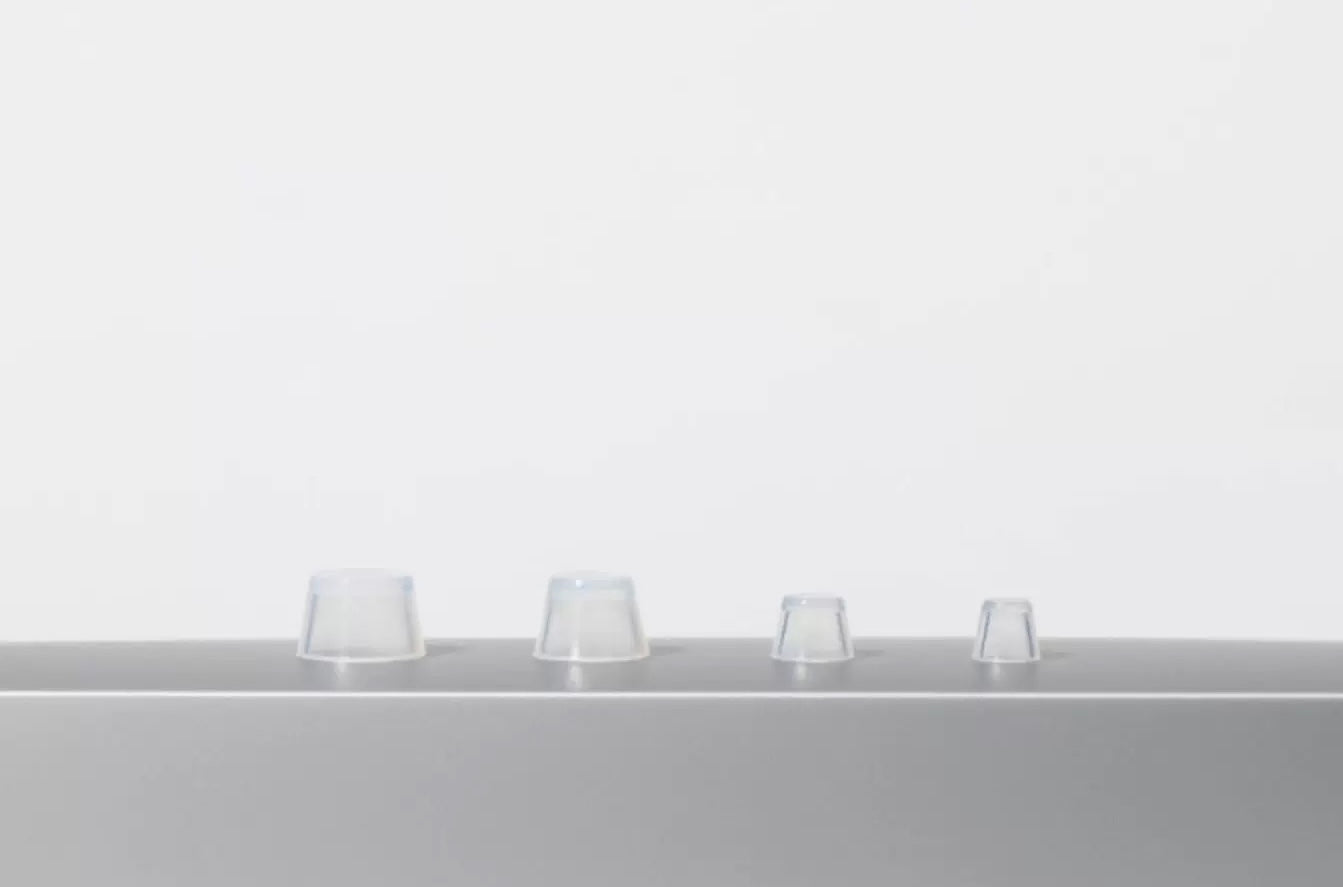 Close-up detail of Orliná transparent feet stud protector installed on Hermès bag base