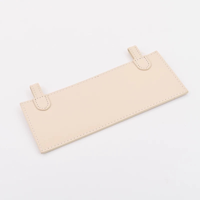 Leather insert inside Hermès Kelly Pochette for hands-free strap attachment in Hermès Craie colour