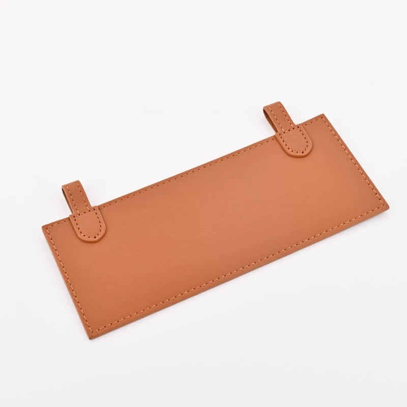 Leather insert inside Hermès Kelly Pochette for hands-free strap attachment in Hermès Gold colour