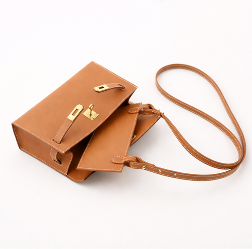 Leather insert inside Hermès Kelly Pochette for hands-free strap attachment in Hermès Gold colour